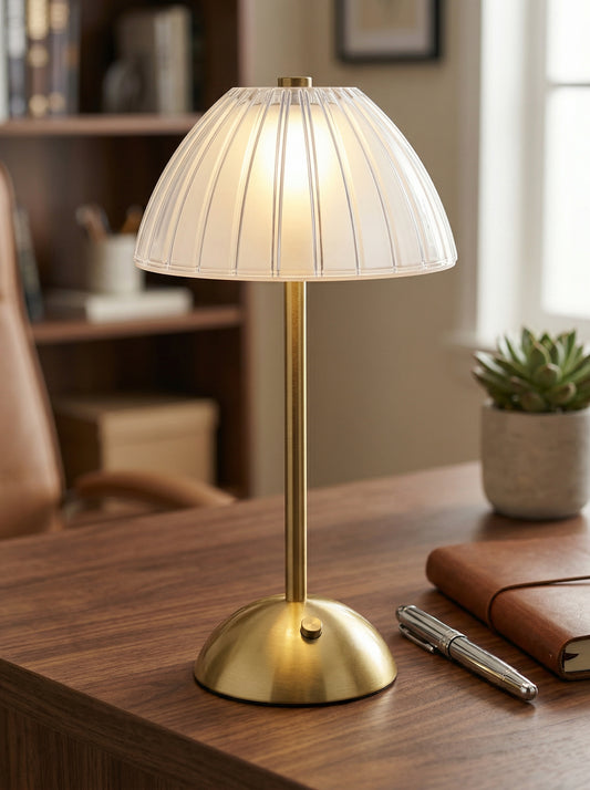 Gold Serin Lamp on a desk with a leather notebook, pen and small succulent