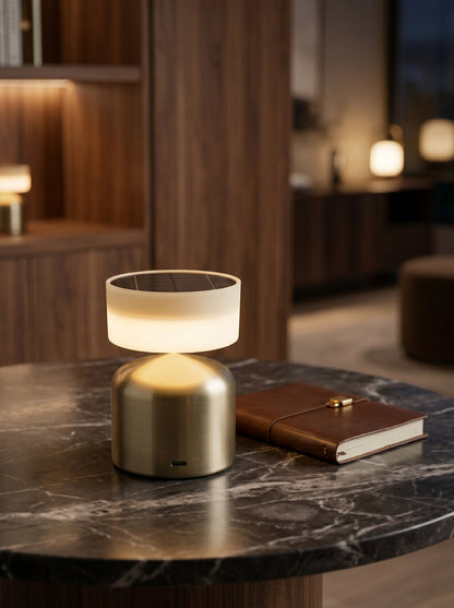 Gold Finch Lamp on a marble side table beside a leather notebook
