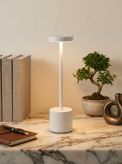 White Egret Lamp on a white marble shelf with a bonsai tree, books and a leather notebook