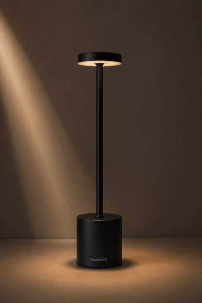 Black Egret Lamp casting a soft pool of warm light on a dark surface