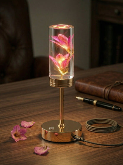Gold and Pink Phoenix Lamp on a wooden table with a fountain pen and scattered pink petals