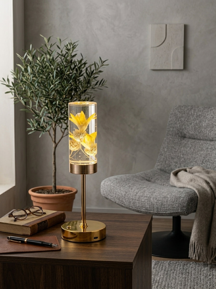Gold and Yellow Phoenix Lamp on a wooden side table next to an olive tree and grey armchair