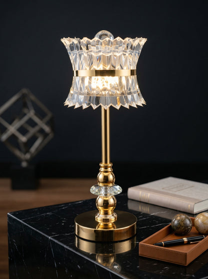 Gold Quetzal Lamp on a black marble desk with a leather tray and books