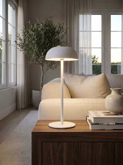 White Swan Lamp on a side table next to a cream sofa in a bright living room